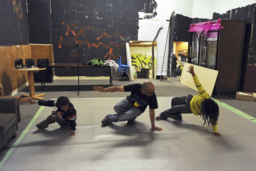 ADVANCE FOR SATURDAY JUNE 20, 2015 AND THEREAFTER In this photo taken June 5, 2015, George Martinez, center, teaches the six step, a series of foundational moves for breakdancing, at his space in a mall in Anchorage, Alaska. Until recently, this mall space was empty, stacked up with old furniture and used as a haunted house at Halloween. This summer, Martinez wants to transform it into something Anchorage doesn't have: A center for urban arts education and hip-hop culture. (Erik Hill/Alaska Dispatch News via AP)