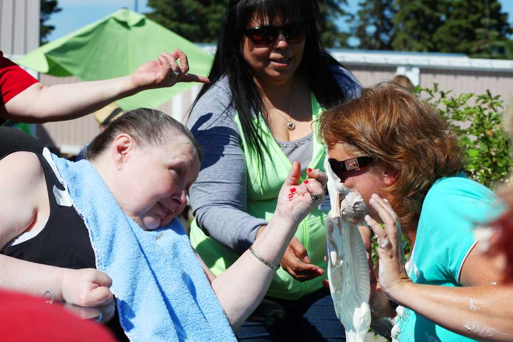 Photo by Kelly Sullivan/ Peninsula Clarion Gwen Johnson, a member of team NeverMind for the Heritage Place nursing home takes a pie in the face for the Alzheimer's Association's The Longest Day fundraiser, Friday, June 19, 2015, in Soldotna, Alaska.