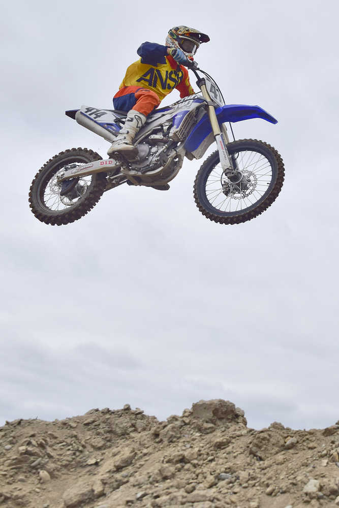 Photo by Rashah McChesney/Peninsula Clarion  Jesse Kelly flies through the air during a race at a state motocross compeition on Saturday June 20, 2015 at Twin City Raceway in Kenai, Alaska.