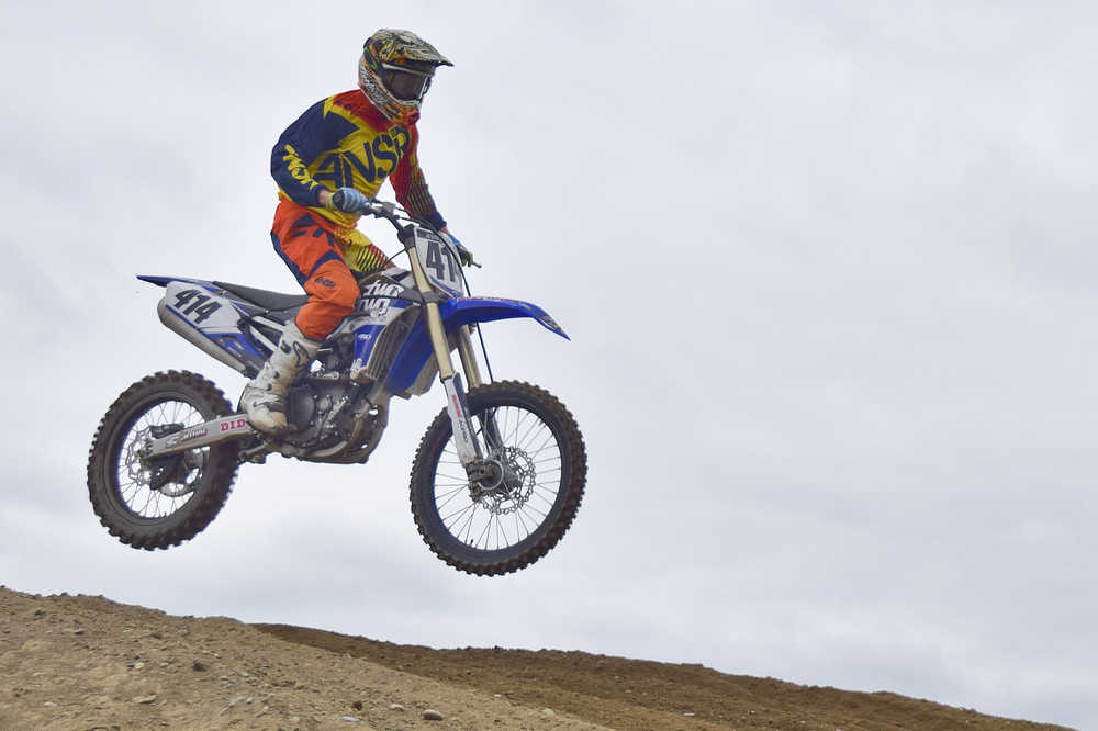 Photo by Rashah McChesney/Peninsula Clarion  Jesse Kelly flies through the air during a race at a state motocross compeition on Saturday June 20, 2015 at Twin City Raceway in Kenai, Alaska.