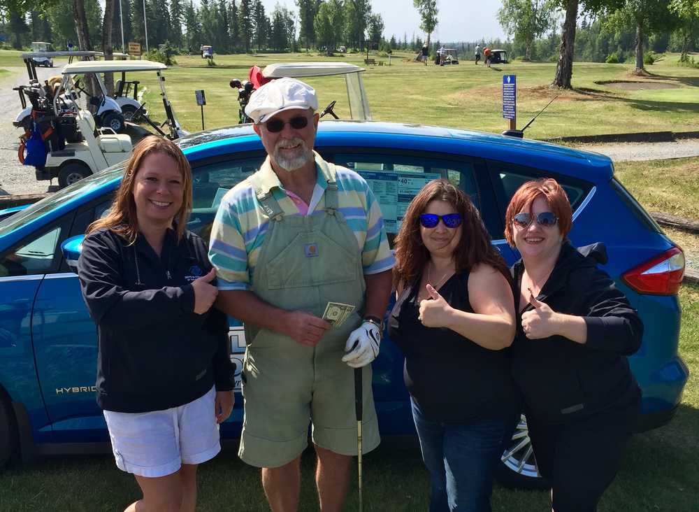 Photo courtesy of Boys and Girls Club  Skip Dove, second from left, poses with the car he won by nailing a hole-in-one on the 10th hole at Kenai Golf Course on Friday at the Boys and Girls Club Tournament. Also pictured, from left, are Heather Schloeman, Alice Nesbitt and Jen Moore with the Boys and Girls Club.