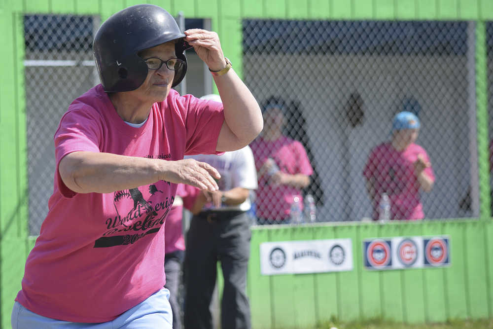 Photo by Rashah McChesney/Peninsula Clarion  Cindy DeHart runs for first during the annual World Series of Baseball event for community members with special needs on June 19, 2015 in Soldotna, Alaska.