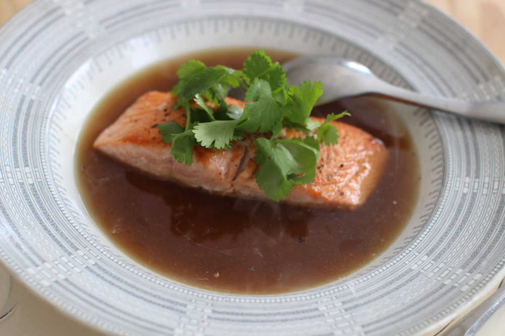 This March 16, 2015 photo shows seared king salmon with lemongrass porcini jus in Concord, NH. (AP Photo/Matthew Mead)