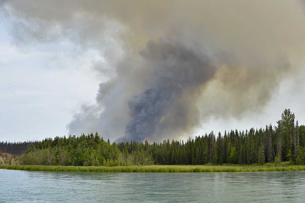 Photo by Rashah McChesney/Peninsula Clarion A smoke column from a controlled burn looms over the Kenai River on Wednesday June 24, 2015 as firefighters work on a prescribed burn to keep the Card Street wildfire from burning out of control in the Skilak Loop Area near Sterling, Alaska.