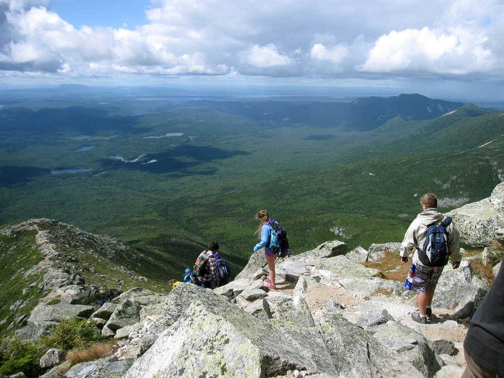 This Aug. 27, 2014 photo shows hikers making their way down Mount Katahdin in Baxter State Park in Maine. The mountain is nearly a mile high and is the tallest mountain in Maine. Its peak is the northern terminus of the Appalachian Trail. (AP Photo/Beth J. Harpaz)