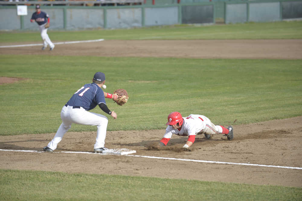 Photo by Megan Pacer/Peninsula Clarion Jordan Washam dives back to first base during a game against the Seattle Studs, Friday, June 26, 2015 at the Coral Seymour Park in Kenai, Alaska.