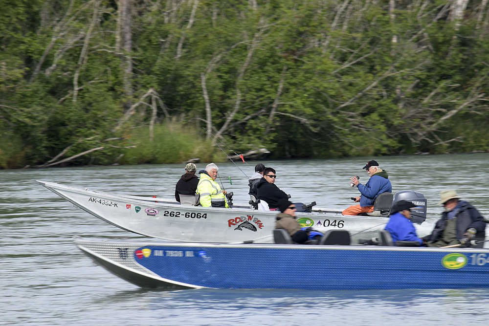 Photo by Rashah McChesney/Peninsula Clarion King salmon fishermen ride upriver during the first day of fishing on the late run of Kenai River king salmon on Wednesday July 1, 2015 near Kenai, Alaska.