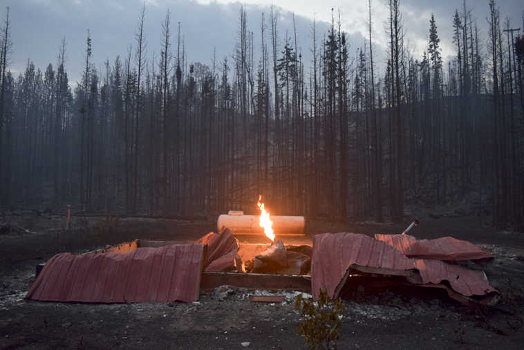 Photo by Rashah McChesney/Peninsula Clarion  A structure on Slough Avenue burns late into the night after the Card Street wild fire burned near the Kenai Key subdivision on June 17, 2015 in Sterling, Alaska. The flames burned high from a damaged gas line.