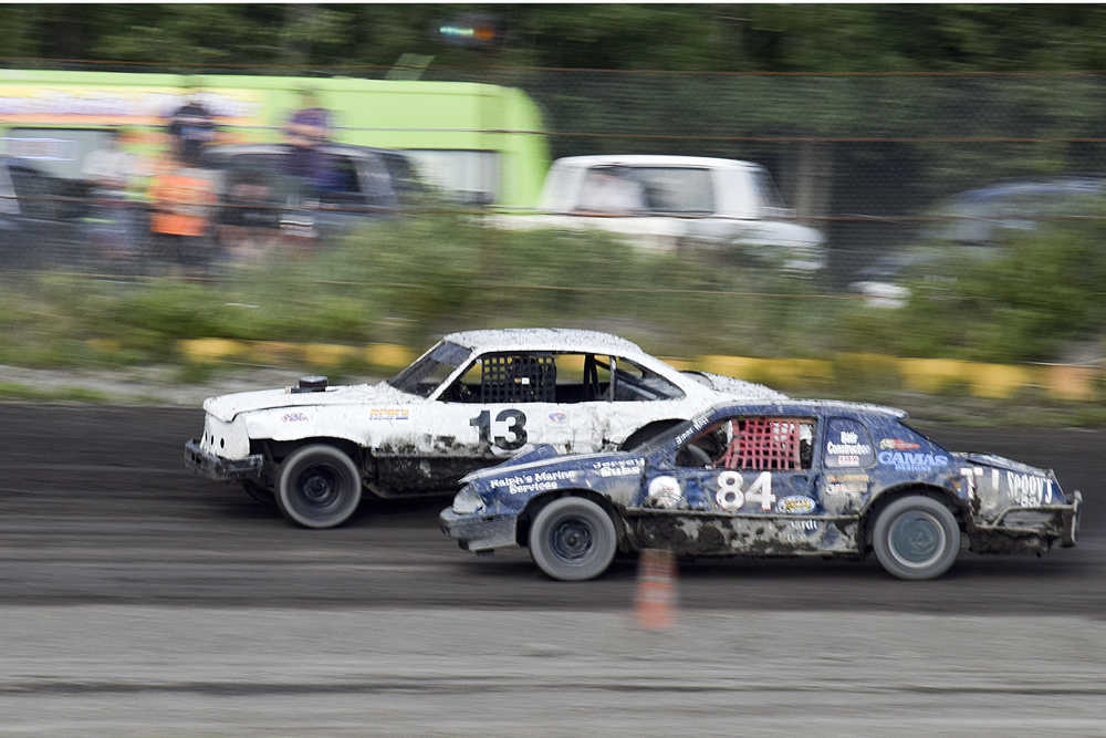 Photo by Rashah McChesney/Peninsula Clarion  Dean Scroggins and Jimmie Hale go head to head during an A-Stock race at the Twin City Raceway on Friday July 3, 2015 in Kenai, Alaska.