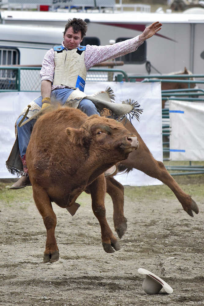 Photo by Rashah McChesney/Peninsula Clarion  Kenny Hackett takes off during the double mugging - a form of calf roping - competition at the Ninilchik Rodeo on Sunday July 5, 2015 in Ninilchik, Alaska.
