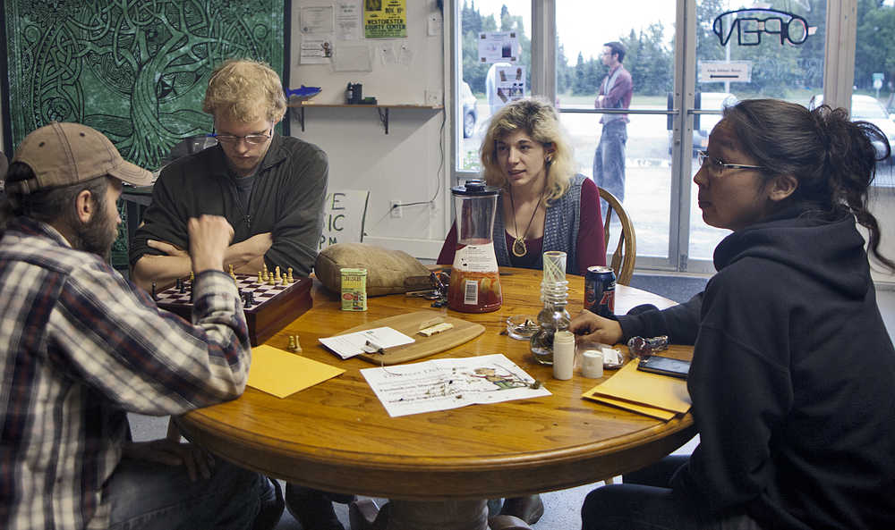 From left to right: Logan Jensen of Homer, Homer Olson of Homer, Caitlin Tebo of Anchorage and Gale Kakaruk of Kenai enjoy socializing and a game of chess on Saturday at the Green Rush Events Clubhouse in Kenai. Photo by Megan Pacer/Peninsula Clarion