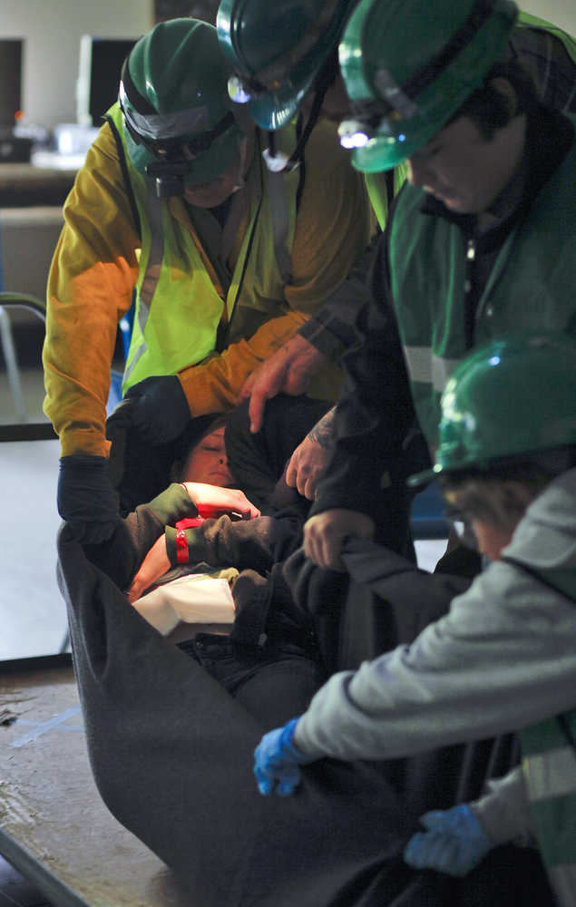 Photo by Rashah McChesney/Peninsula Clarion A group of Community Emergency Response Team trainees transport a mock earthquake victim in a blanket during a disaster drill Saturday July 12, 2014 in Soldotna, Alaska. 10 communities on the Kenai Peninsula have CERT members.