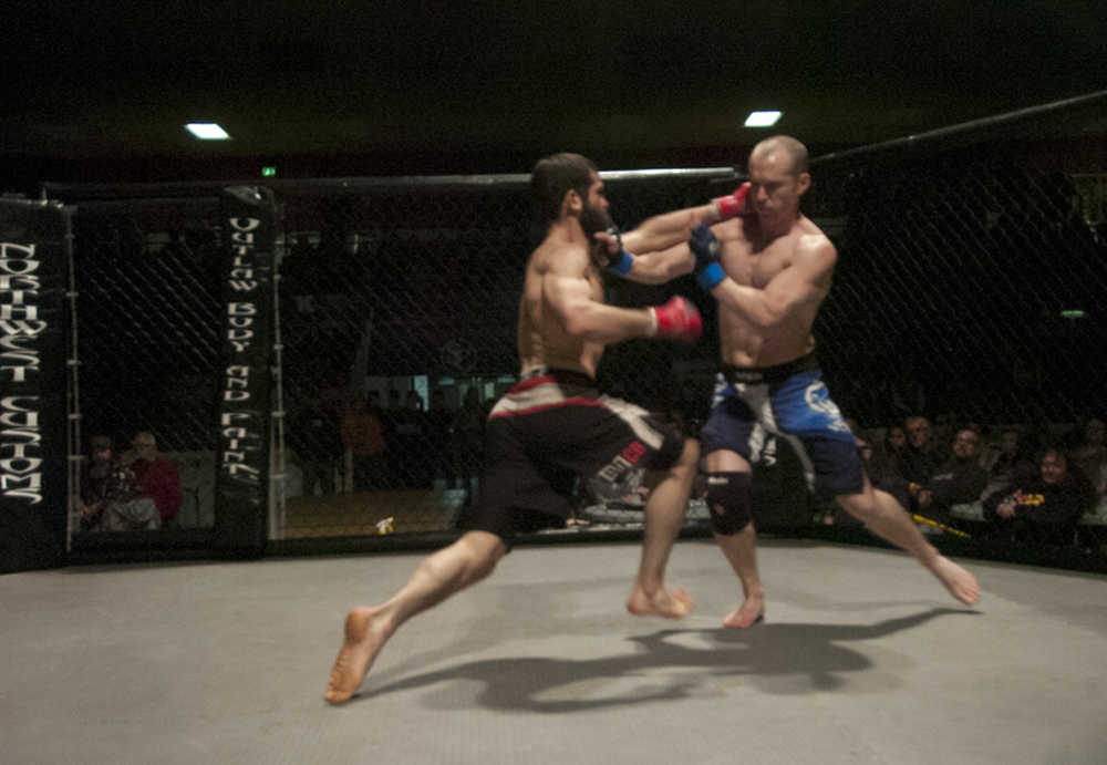Photo by Rashah McChesney/Peninsula Clarion In this March 30, 2013 file photo (left) Mitch Fields and Mark Stogsdill both land hits during their title fight at the Peninsula Fighting Championships at the Soldotna Sports Center in Soldotna, Alaska. The Soldotna City Council is considering a resolution to award a contract to one of the two mixed martial arts promoters in the central Kenai Peninsula area as its sole purveyor of MMA events.