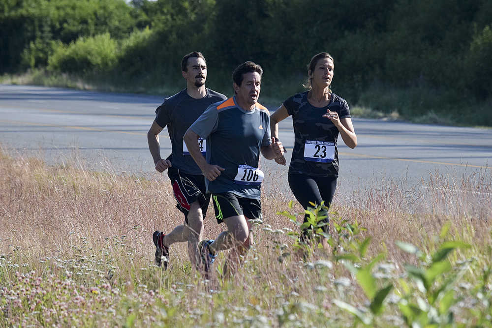 Photo by Rashah McChesney/Peninsula Clarion Racers run down the side of the Kenai Spur Highway during the 5k portion of the annual Rotary Unity Run on Saturday July 11, 2015 in Soldotna, Alaska.