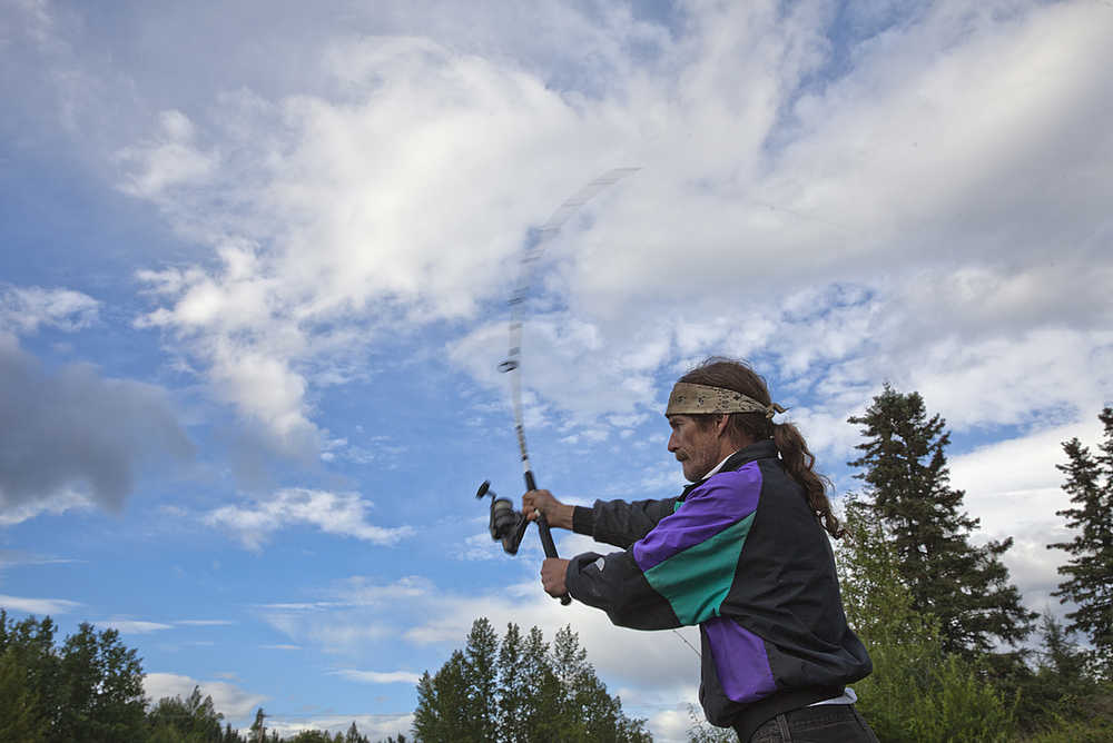 Photo by Rashah McChesney/Peninsula Clarion  Robert Mitchell, of Sterling, fishes for red salmon at the mouth of the Moose River on Tuesday July 15, 2015 in the Izaak Walton Campground in Sterling, Alaska. Mitchell joked that he was a hungry hippie seeking dinner.