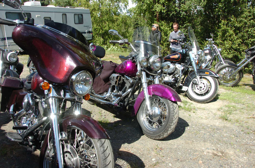 Photo by Megan Pacer/Peninsula Clarion Southern Peninsula ABATE member Brittney Sparhawk pulls the winning raffle hours before her wedding after the nonprofit's bike rally on Saturday at Renegade's Custom Cycle in Soldotna, Alaska.