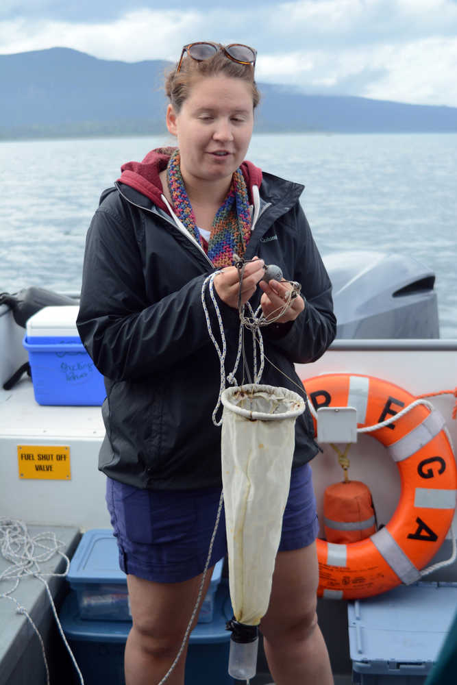 Leah Thon prepares to toss overboard a net and bottle to do a plankton tow.
