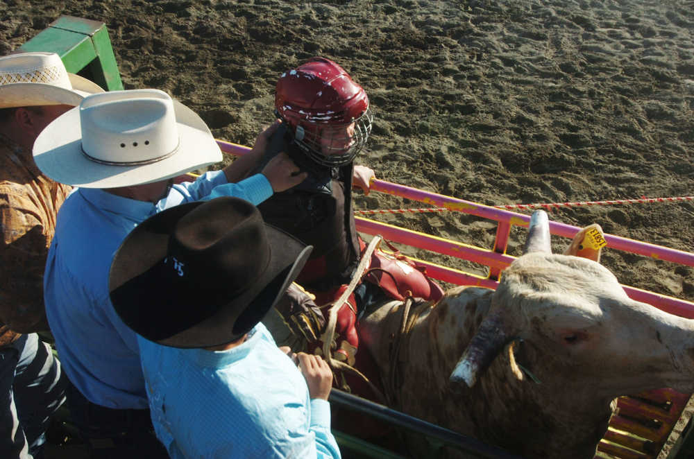 Photo by Megan Pacer/Peninsula Clarion Several barrel racers warm up before, "Beauty and the Beast," a combined barrel racing and bull riding competition on Friday night during the Progress Days Rodeo at the Soldotna Rodeo Grounds.