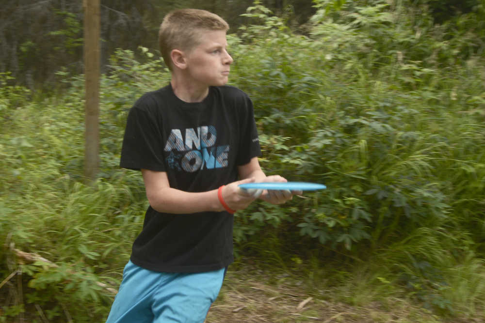 Ben Boettger/Peninsula Clarion Lance Chilton, the youngest competitor in a disc golf tournament at Tsalteshi Trails, concentrates before taking a shot on Saturday, July 25.