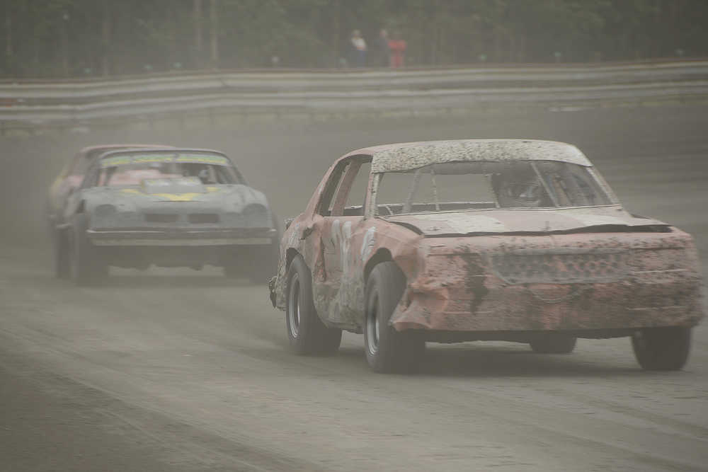 By Joey Klecka/Peninsula Clarion Keith Jones (foreground) powers along the backstretch Saturday night in the A-Stock division at Twin City Raceway in Kenai.