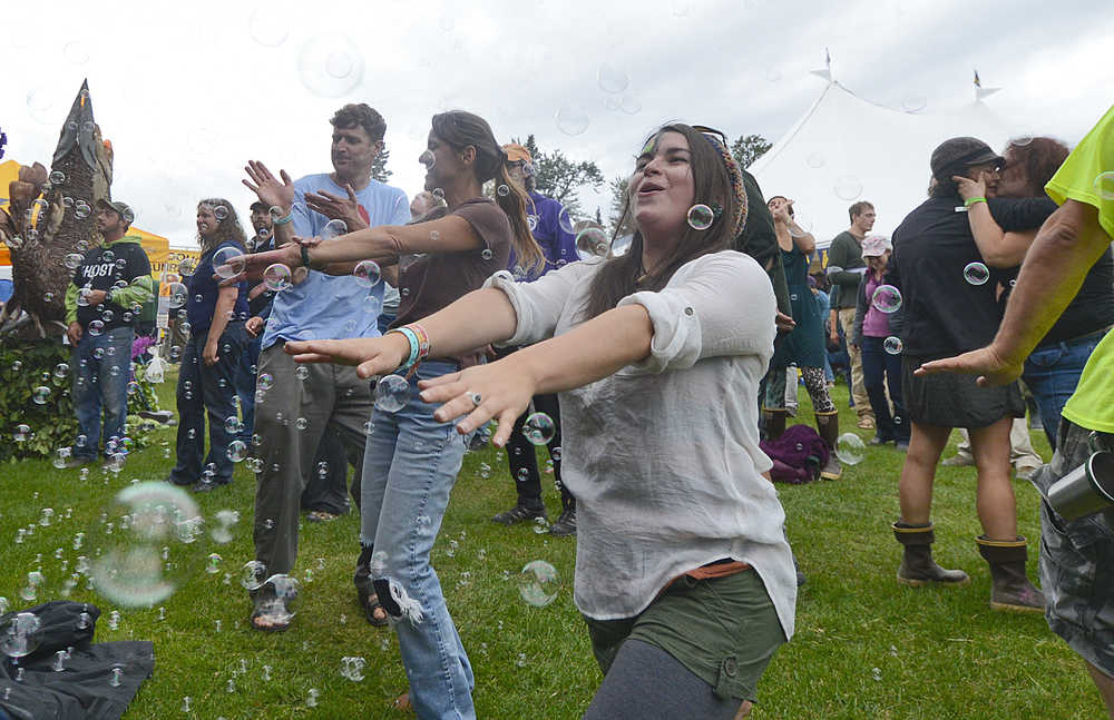 Photo by Rashah McChesney/Peninsula Clarion  Audience members dance through a haze of bubbles during The Big Wu's show Friday, Aug. 2, 2013 at Salmonstock. The festival is back again this year, this time as Salmonfest.