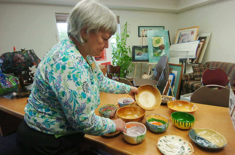 Photo by Megan Pacer/Peninsula Clarion Linda Swarner, executive director of the Kenai Peninsula Food Bank, organizes bowls donated for the annual Soup Supper and Auction on Wednesday afternoon at the Kenai Peninsula Food Bank in Soldtona. The Soup Supper and Auction is a fundraiser for the food bank that draws around 400 participants each year and sends ticket holder home with hand-crafted bowls. Tickets for the fundraiser will rise from $40 to $50 after August 1.