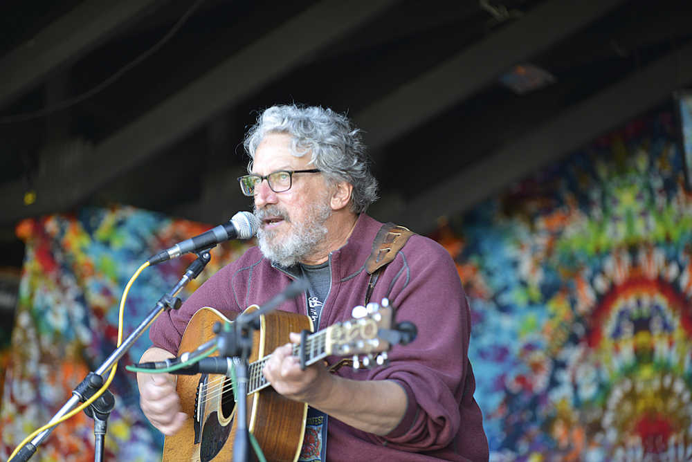 Photo by Megan Pacer/Peninsula Clarion Seattle musician Jim Page serenades an audiance as the first performer on Salmonfest's main stage on Saturday, Aug. 1, 2015 in Ninilchik, Alaska.
