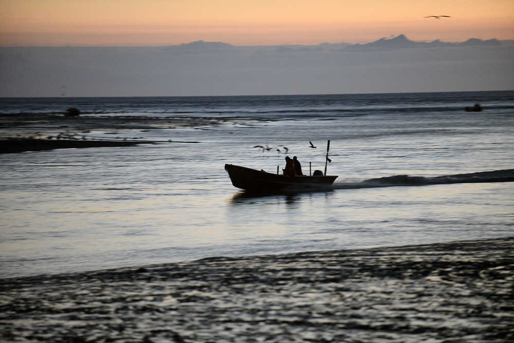 Photo by Rashah McChesney/Peninsula Clarion A setnet skiff races up the Kasilof River during the first overnight fishing period in the Kasilof Special Harvest Area at the mouth of the river on July 7. Personal use dipnetters, commercial setnet and drift gillnet fishermen crowd into a two mile area around the mouth of the river when the special harvest area is opened.