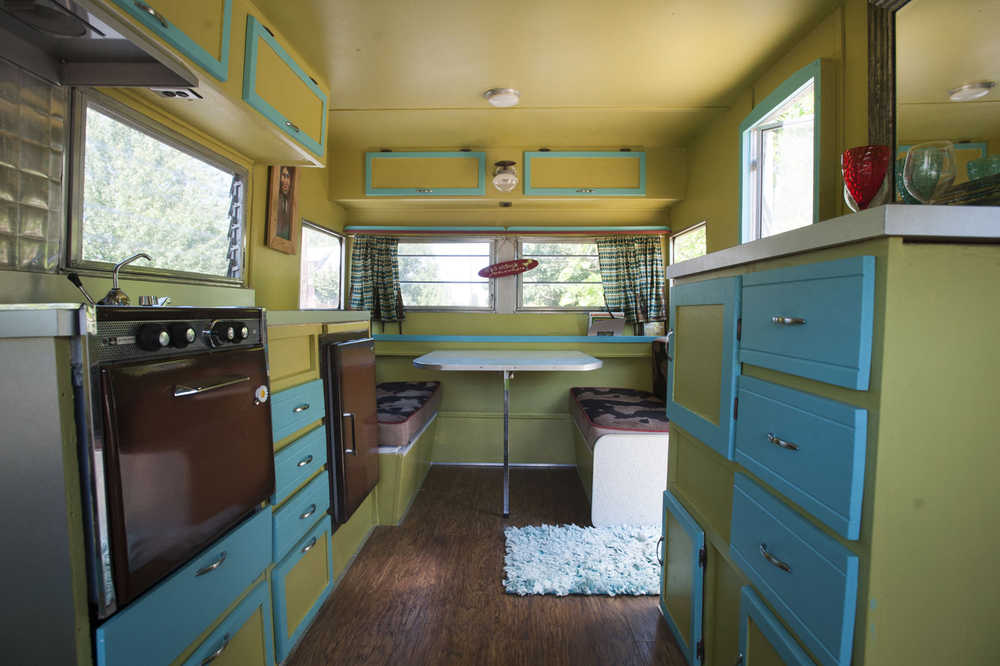 This Friday, July 17, 2015 photo shows the inside of  Deanna Wohlgemuth's vintage Aristocrat camper in Vancouver, Wash.   Wohlgemuth's dubbed the camper "Matilda," which is a 1963 16-foot Aristocrat camper she rescued from the junk heap, she now rents it our for camping and events. (Natalie Behring/The Columbian via AP) MANDATORY CREDIT