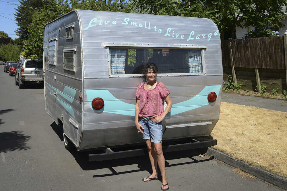 Deanna Wohlgemuth stands outside her camper on July 17, 2015 in Vancouver, Wash.   Wohlgemuth's dubbed the camper "Matilda," which is a 1963 16-foot Aristocrat camper she rescued from the junk heap, she now rents it our for camping and events. (Natalie Behring/The Columbian via AP) MANDATORY CREDIT