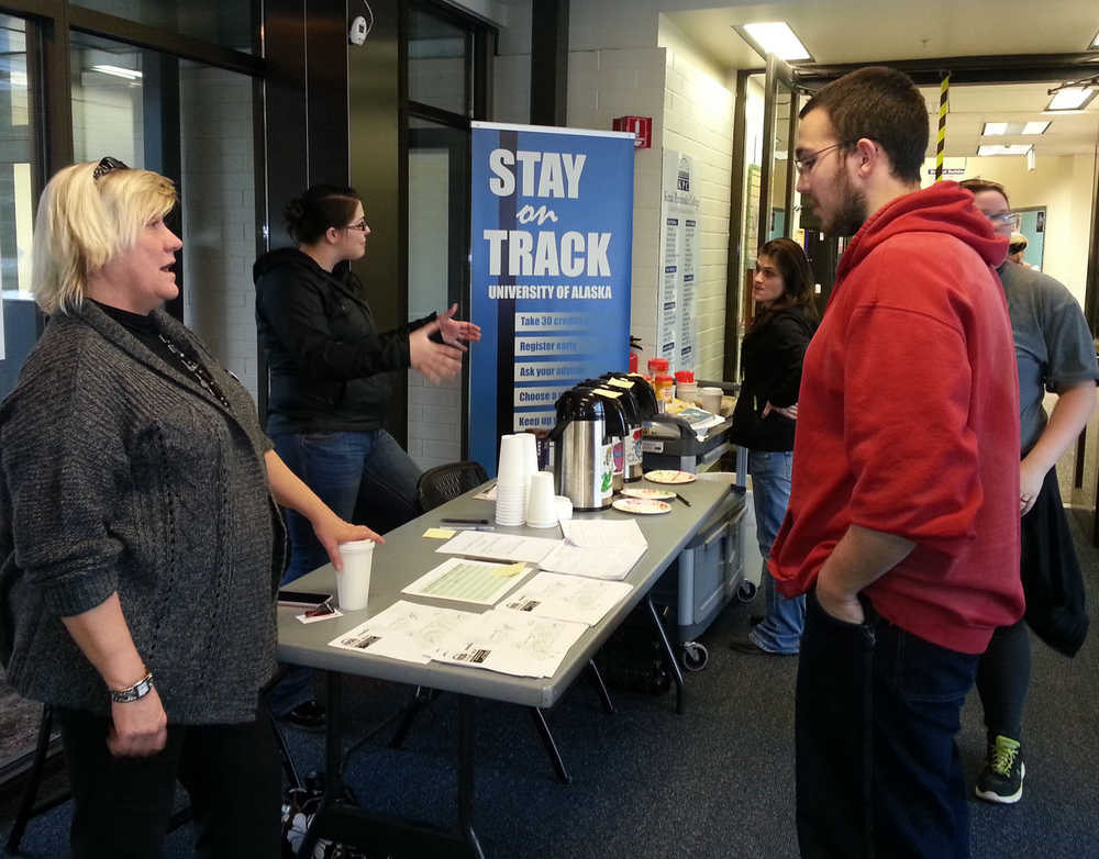 Clarion file photo In this Jan. 12, 2015 file photo Kenai Peninsula College student advisers Shauna Thornton and Marsea Hansen welcome college students back to the Kenai River Campus Monday for the first day of classes after the winter break. The University of Alaska satellite campus will take be absorbing nearly $425,000 in cuts to its budget.