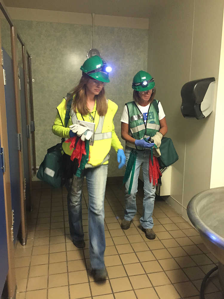 Photo by Megan Pacer/Peninsula Clarion Community Emergency Respone Team course members Leah Vik (left) and Daughn Carpenter (right) search a bathroom for volunteers posing as victims during a simulated earthquake exercise held Saturday Aug. 8, 2015 at Soldotna Prep School in Soldotna, Alaska.