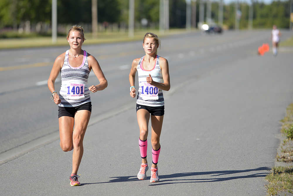 Photo by Rashah McChesney/Peninsula Clarion  Taylor Ostrander and Allie Ostrander lead the 10k portion of the Run for Women on Saturday August 8, 2015 in Kenai, Alaska.