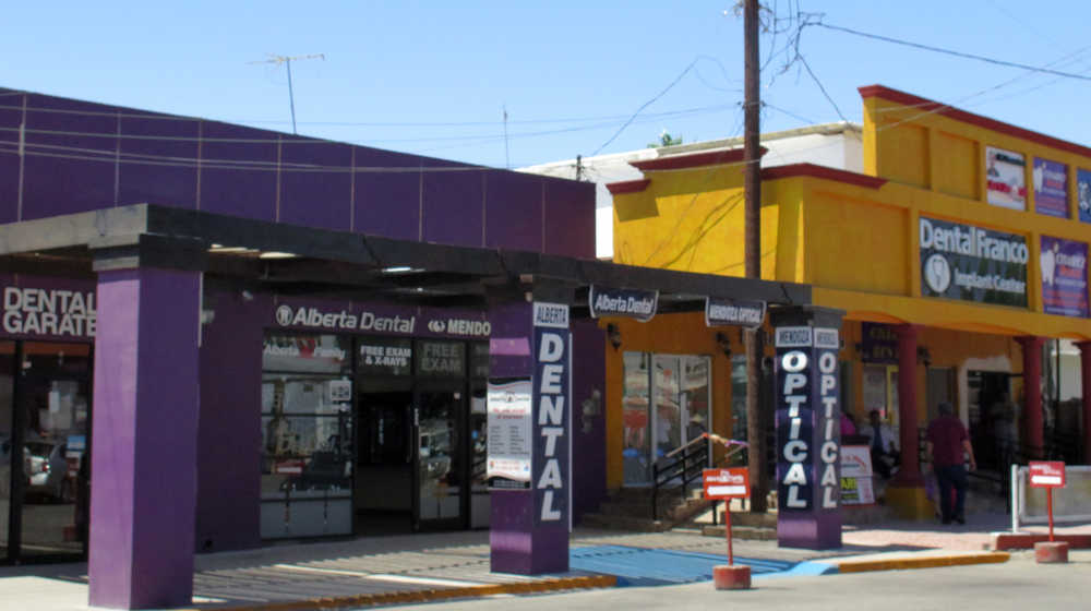 In this Thursday, April 30, 2015 photo, a street full of a dental offices is seen in Los Algodones, Mexico, which sits on the border with California. Thousands of Americans and Canadians travel to Los Algodones each year for affordable and reliable dental work from dentists who speak English and sometimes accept U.S. insurance. The trip, even counting the cost of traveling long distances, is often more affordable than getting dental care in the United States. (AP Photo/Astrid Galván)