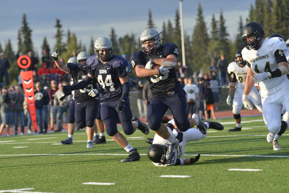 Ben Boettger/Peninsula Clarion  evades a would-be tackler during a game at Soldotna High School on Friday, August 14.