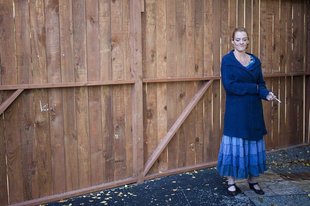 Photo by Rashah McChesney/Peninsula Clarion  Aubrey Austin takes a smoke break at the LeeShore Center on Friday August 14, 2015 in Kenai, Alaska. Austin has been living at the shelter for two months, but plans to move out of state soon to be closer to her two young children. The shelter is celebrating 30 years of service to the community. At present, all 32 of its beds are full.