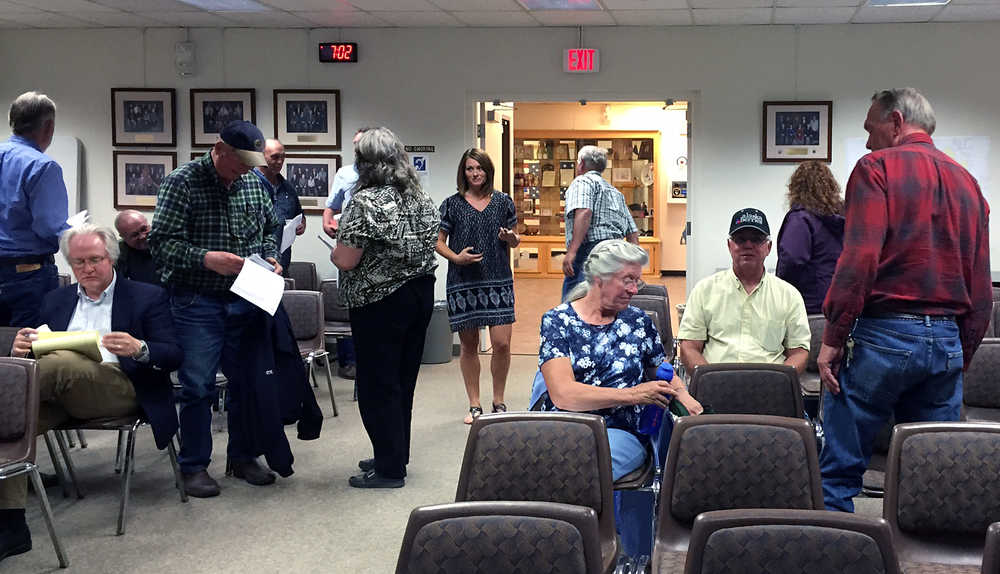 Photo by Megan Pacer/Peninsula Clarion  Several residents prepare to the leave the Kenai Peninsula Borough Assembly Chambers after a public hearing on a proposal to form a special assessment district to help mitigate flooding along Kalifornsky Beach Road on Thursday August 18, 2015 in Soldotna, Alaska.