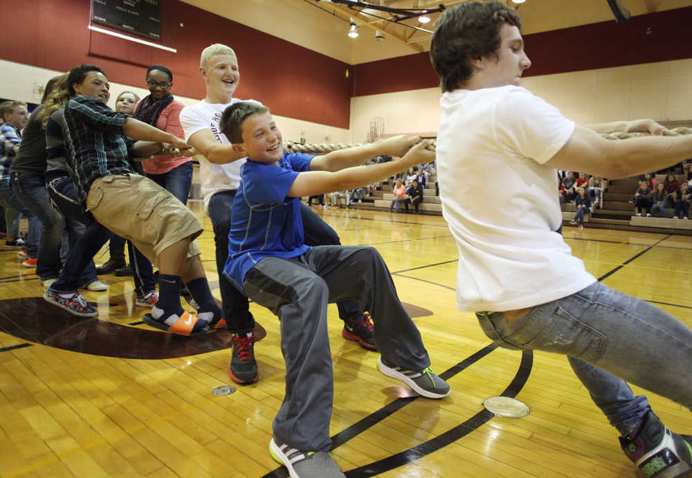 Photo by Kelly Sullivan/ Peninsula Clarion Harley Copenharve and Ben Vanhoose pull at the front of their team's side of the rope during a friendly tug-of-war game Wednesday, Aug. 19, 2015, at Soldotna Prep in Soldotna, Alaska. Principal Curtis Schmidt said he likes to get his students moving and excited about their new school on the first day back from summer vacation.