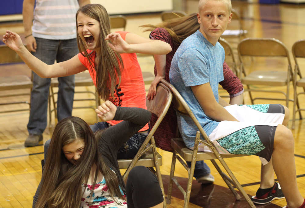 Photo by Kelly Sullivan/ Peninsula Clarion (Left) Cassie Haeg, Jayden Kemp and Jacob Wile make it to the final rounds in musical chairs Wednesday, Aug. 19, 2015, at Soldotna Prep in Soldotna, Alaska.