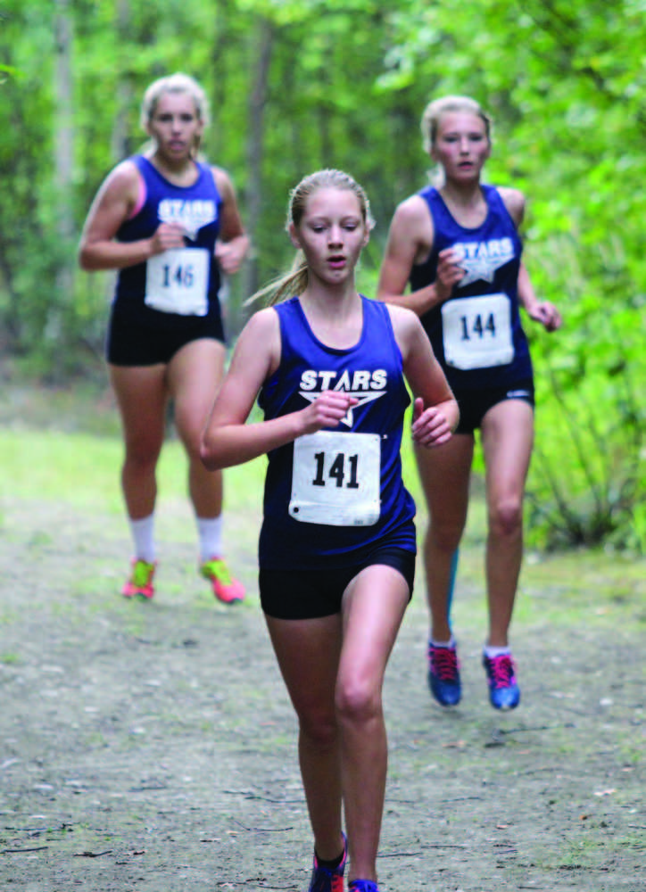 Soldotna's Molly Erickson leads teammates Emily Werner, left, and Daisy Nelson down a decline in the trail during the Colony Invitational Aug. 15 at Colony High School in Palmer. Soldotna finished second in the girls team standings.