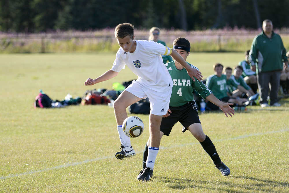 Photo by Rashah McChesney/Peninsula Clarion  Cook Inlet Academy's Connor Leaf takes control of the ball during a game against Delta Junction on Thursday August 20, 2015 in Kenai, Alaska.