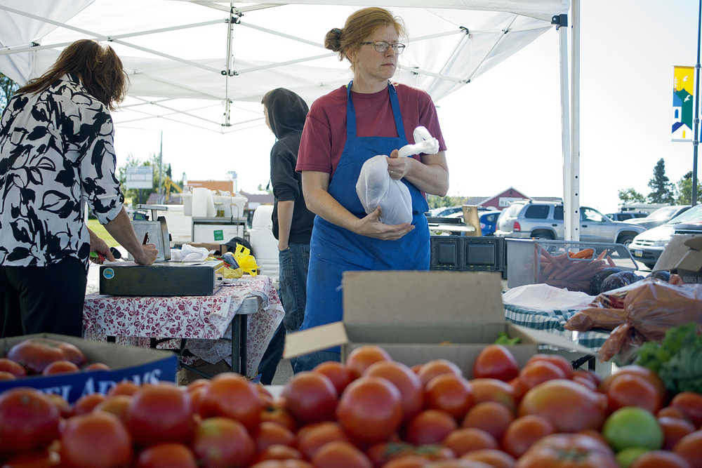 Photo by Rashah McChesney/Peninsula Clarion  Annetta Villa sells Valley's Bounty produce on Saturday August 22, 2015 at a farmer's market at the Kenai Chamber of Commerce and Visitors Center in Kenai, Alaska.