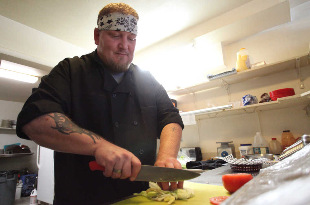 Photo by Kelly Sullivan/ Peninsula Clarion Richard Garrett has been running his first kitchen since June, Sunday, Aug. 23, 2015, at Garrett's Grill located inside The Place bar in Kenai, Alaska.