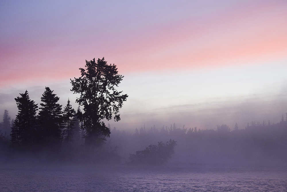 Photo by Rashah McChesney/Peninsula Clarion  Colors combine on the Kenai River as the sun rise on August 24, 2015 near Kenai, Alaska.