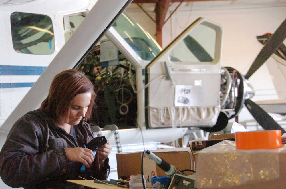 Ben Boettger/Peninsula Clarion Casee Chevalier clips a wire in the hangar workshop of Peninsula Aero Tech avionic services on Thursday, August 27 at the Kenai Municipal Airport. Peninsula Aero Tech is one of the businesses whose lease rates on airport property are increasing.