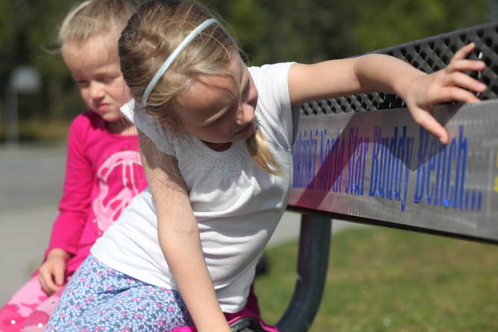 Photo by Kelly Sullivan/ Peninsula Clarion (Left) Abby White and Emery Quick take a rest on the Buddy Bench during lunch recess Friday, Aug. 28, 2015, at Nikiski North Star Elementary in Nikiski, Alaska.