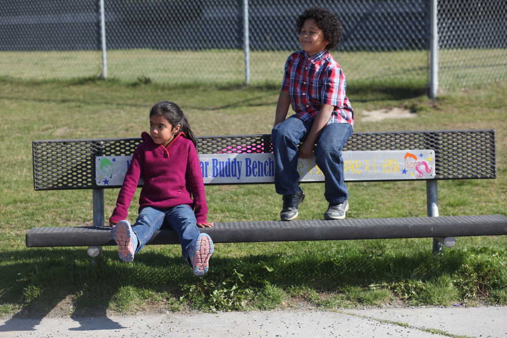 Photo by Kelly Sullivan/ Peninsula Clarion (Left) Angelina Llanez and Jebideth Martin watch the playground from the Buddy Bench before meeting a group of friends Friday, Aug. 28, 2015, at Nikiski North Star Elementary in Nikiski, Alaska.