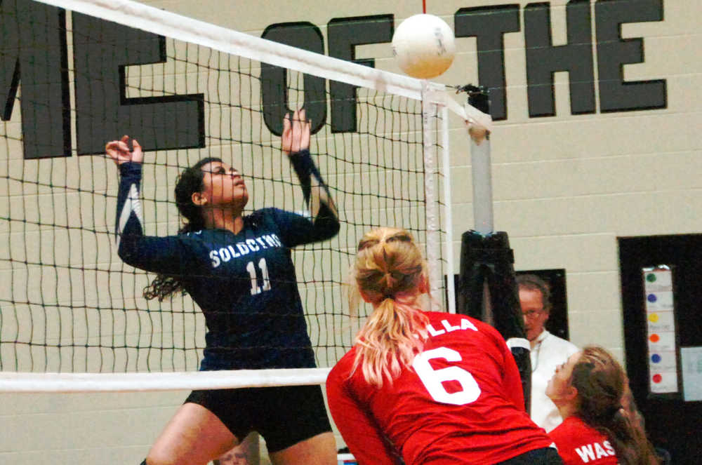 Ben Boettger/Peninsula Clarion Soldotna High School volleyball player  hits the ball over the net during a game on Saturday, August 29 at Nikiski High School.