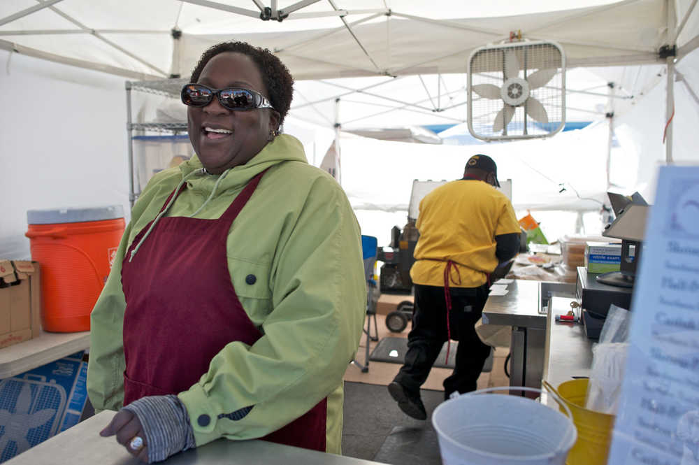 Morris News Service Photo by Michael Penn/Juneau Empire Olivia Carr-Odom talks about President Barack Obama's upcoming visit to Alaska while working her "Simply Southern" food booth at the Anchorage Market & Festival on Sunday. She is a 45 year resident in Alaska.