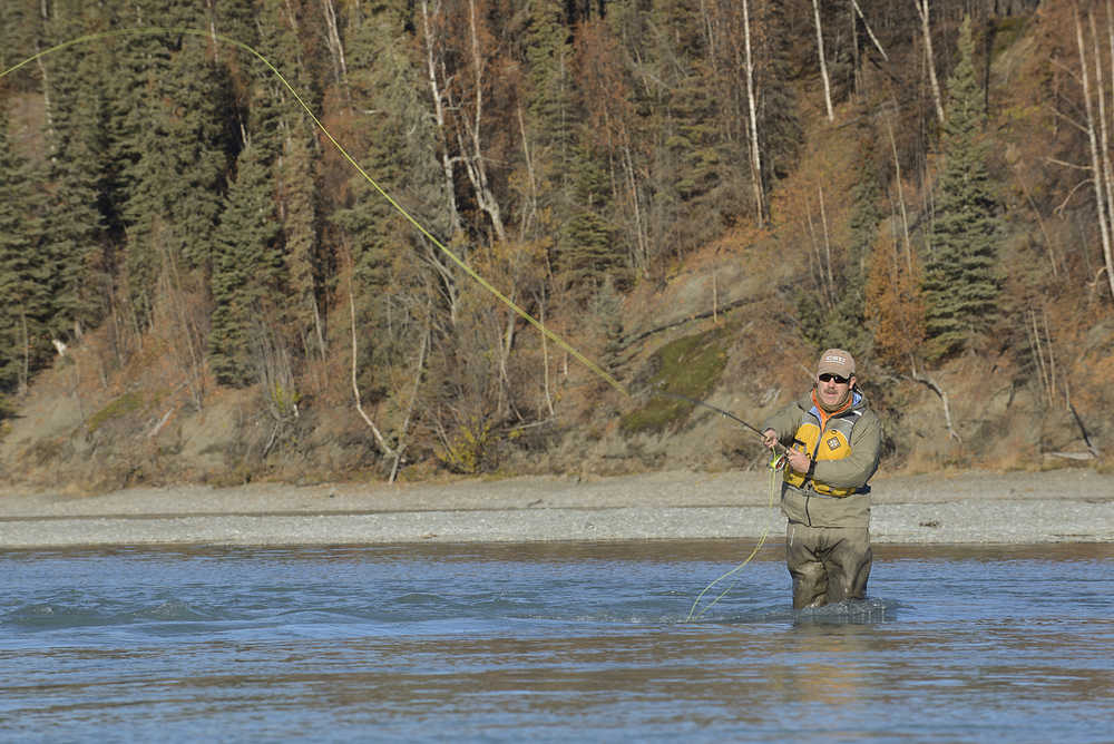 Photo by Rashah McChesney/Peninsula Clarion  In this October 19, 2014 file photo an angler fishes on the Kenai River near its outlet from Skilak Lake. Rainbow trout fishing has been hot in this area and river-wide for weeks.